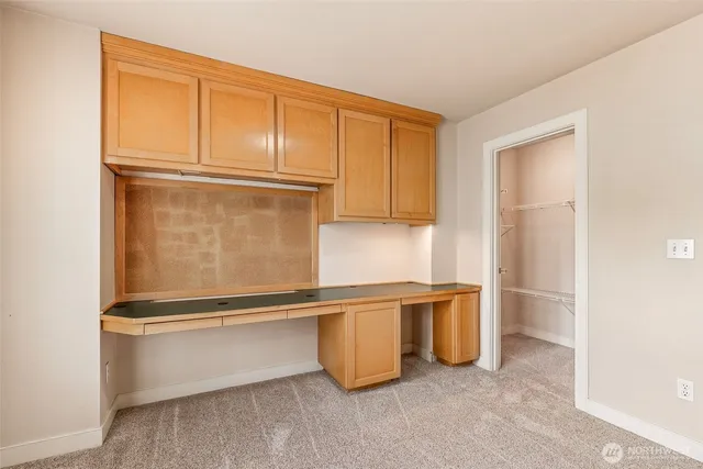 a living room with a sink and a refrigerator
