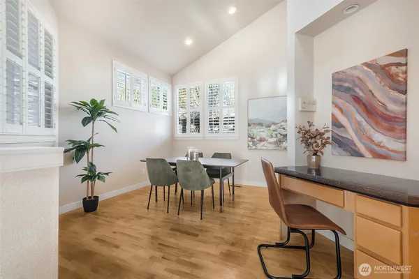 a view of a dining room with furniture window and wooden floor