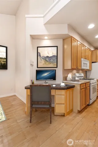 a living room with stainless steel appliances kitchen island granite countertop furniture and a view of kitchen