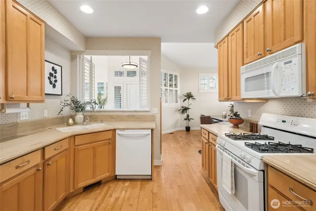 a kitchen with a sink stove and cabinets