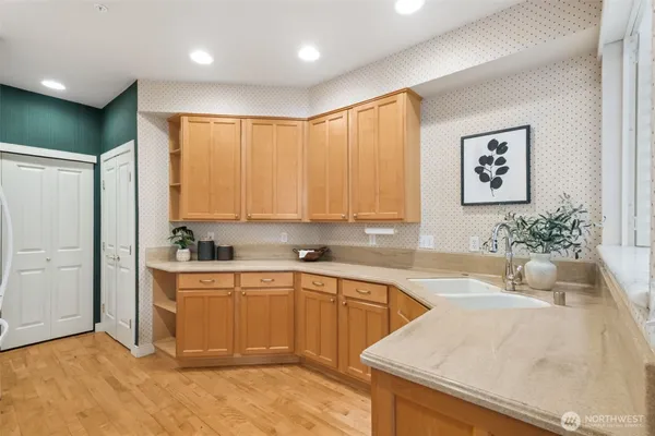 a kitchen with a sink cabinets and window