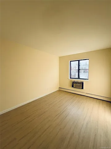 a view of a room with wooden floor and window