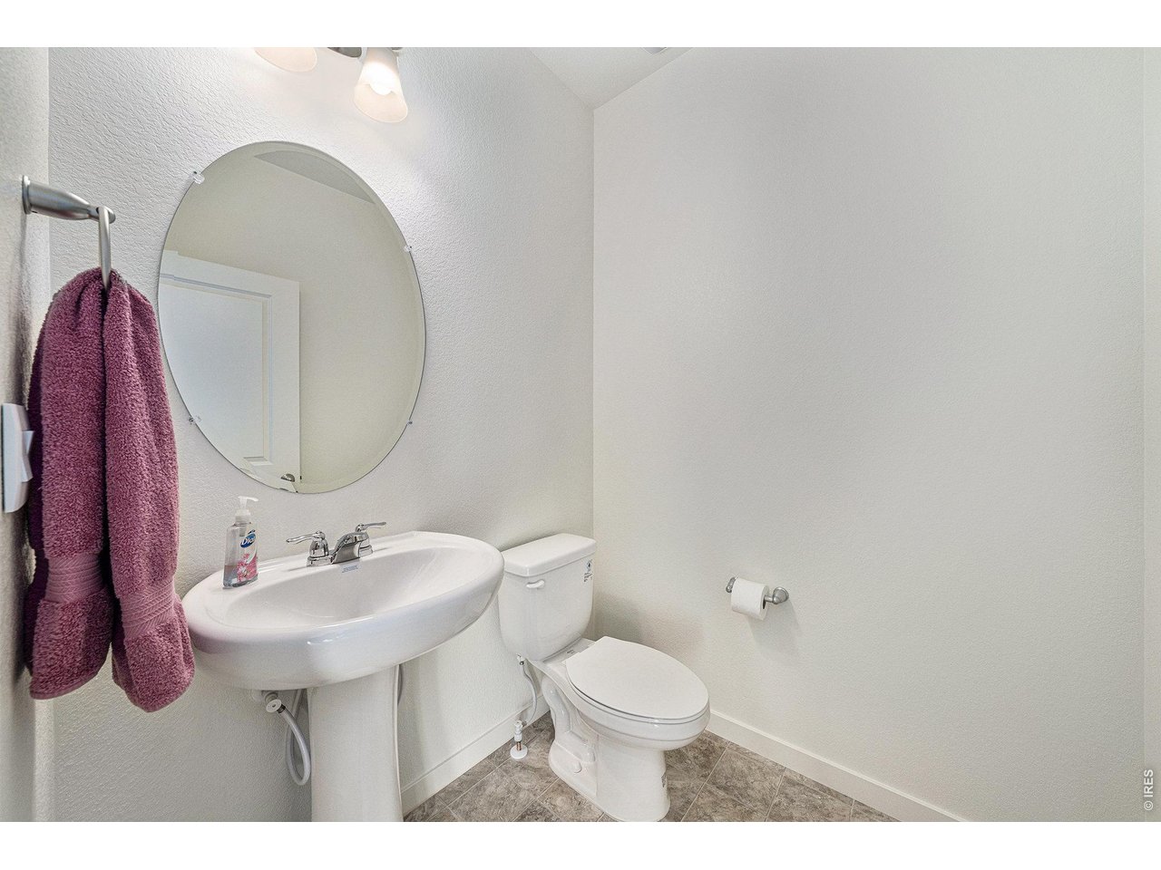 439 Bluebird Road Johnstown, CO 80534 - Photo 12 of 33 Half bathroom on the main floor with an upgraded sink pedestal.