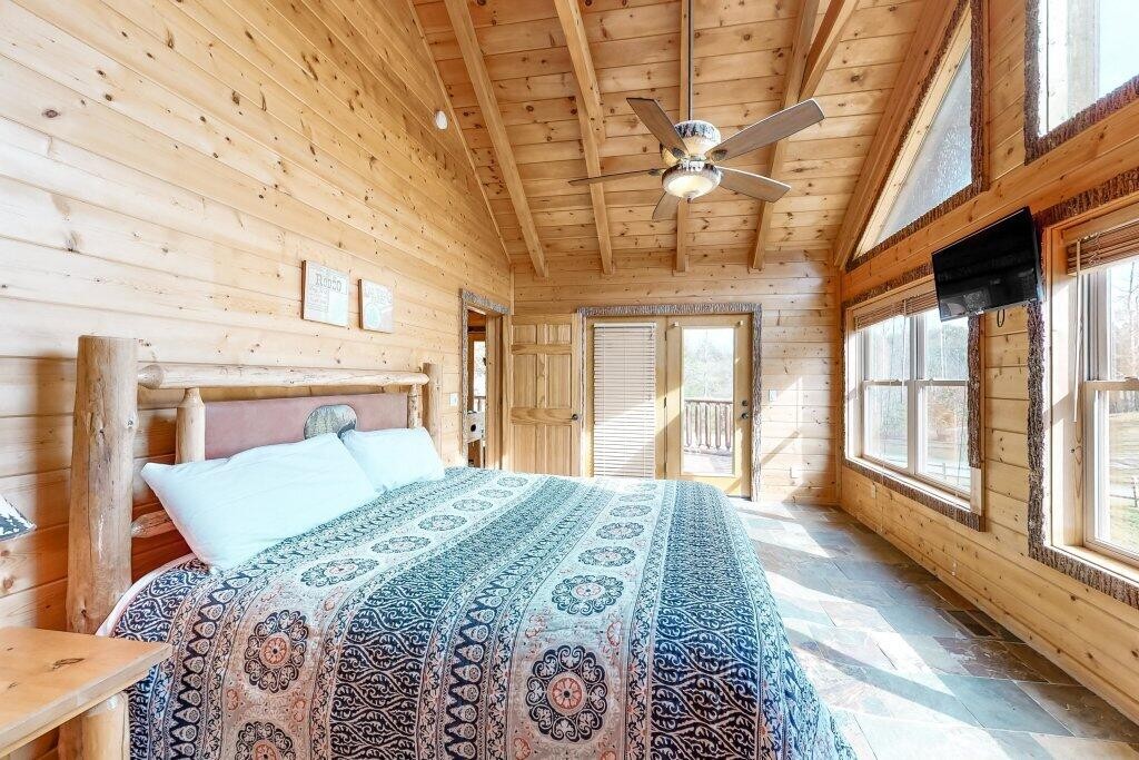 2556 Treehouse Lane Sevierville, TN 37876 - Photo 13 of 24 a bedroom with a large bed and a chandelier
