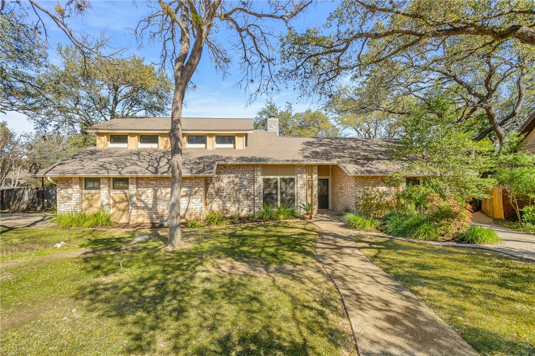 7803 Deer Ridge Circle Austin, TX 78759 - Photo 1 of 1 a front view of a house with a garden