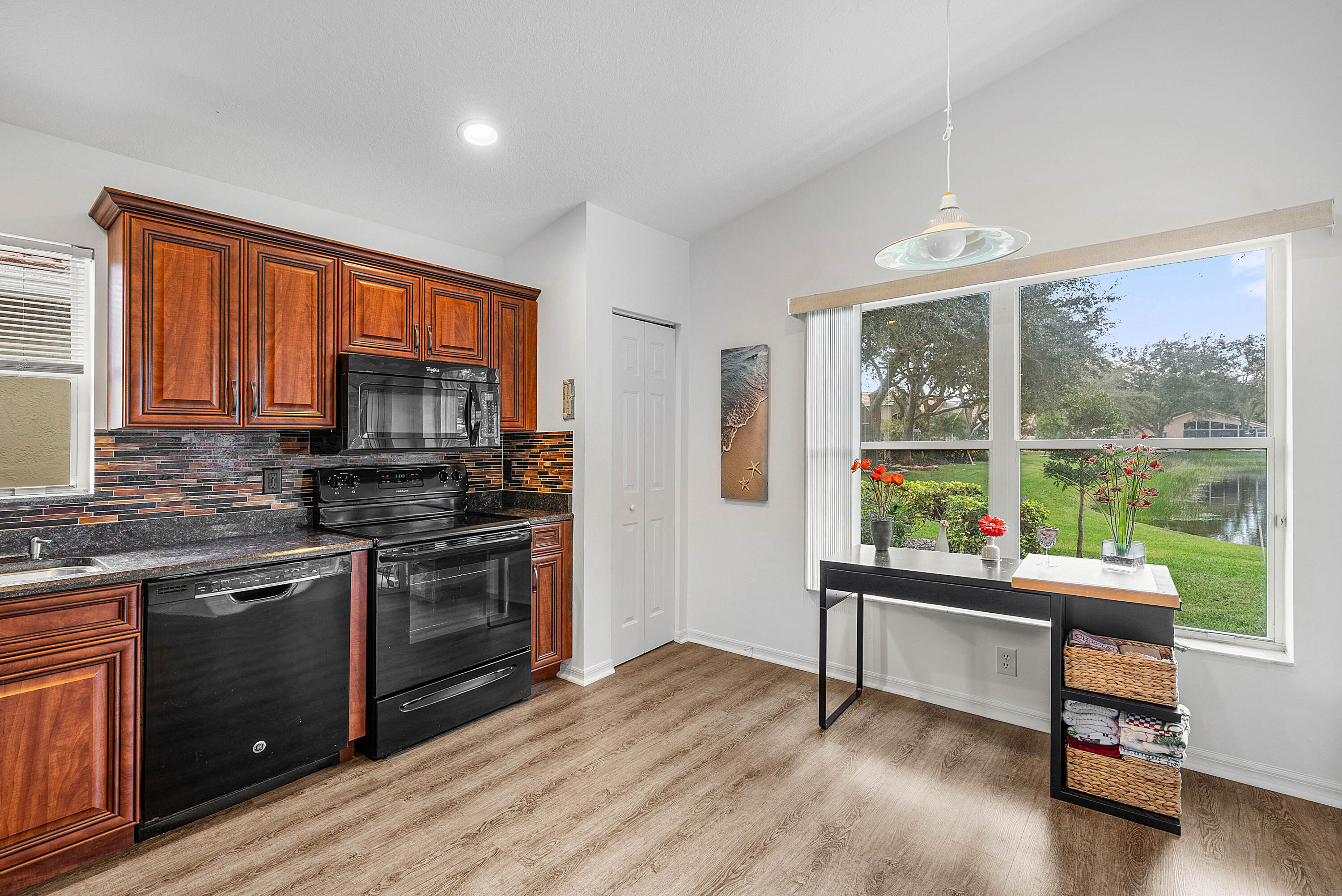 7304 Modena Drive Boynton Beach, FL 33437 - Photo 11 of 35 a kitchen with stainless steel appliances granite countertop a stove a sink and a refrigerator