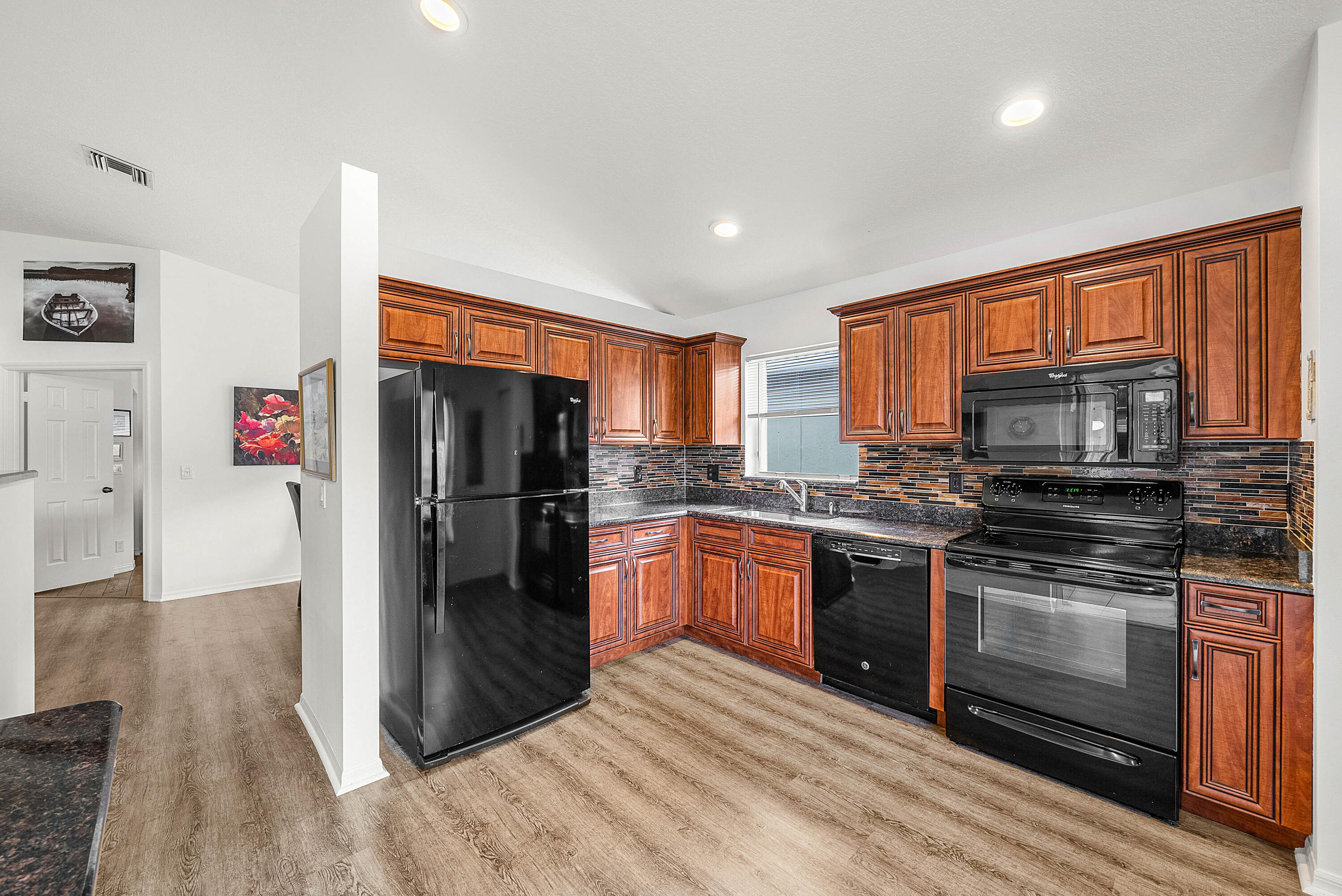 7304 Modena Drive Boynton Beach, FL 33437 - Photo 12 of 35 a kitchen with stainless steel appliances granite countertop a refrigerator stove and oven