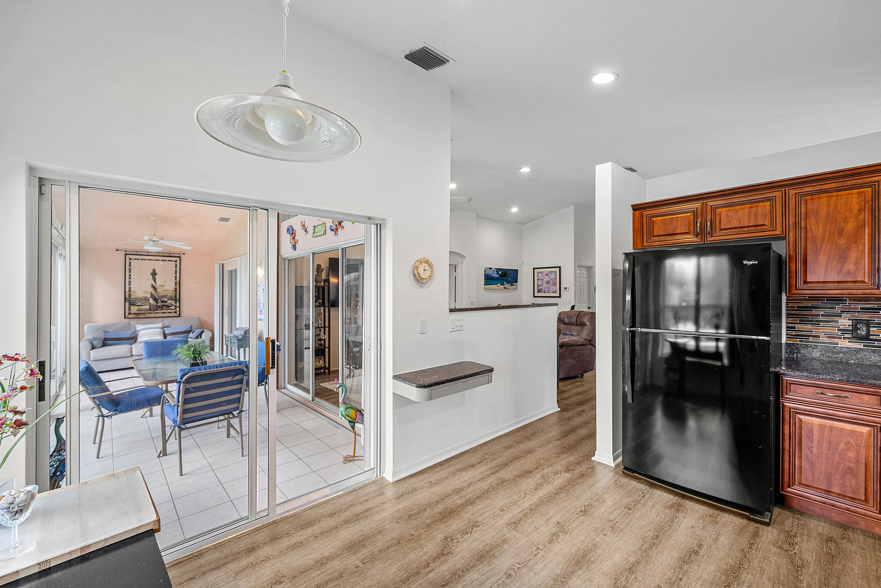 7304 Modena Drive Boynton Beach, FL 33437 - Photo 14 of 35 a kitchen with stainless steel appliances granite countertop a refrigerator and a stove top oven
