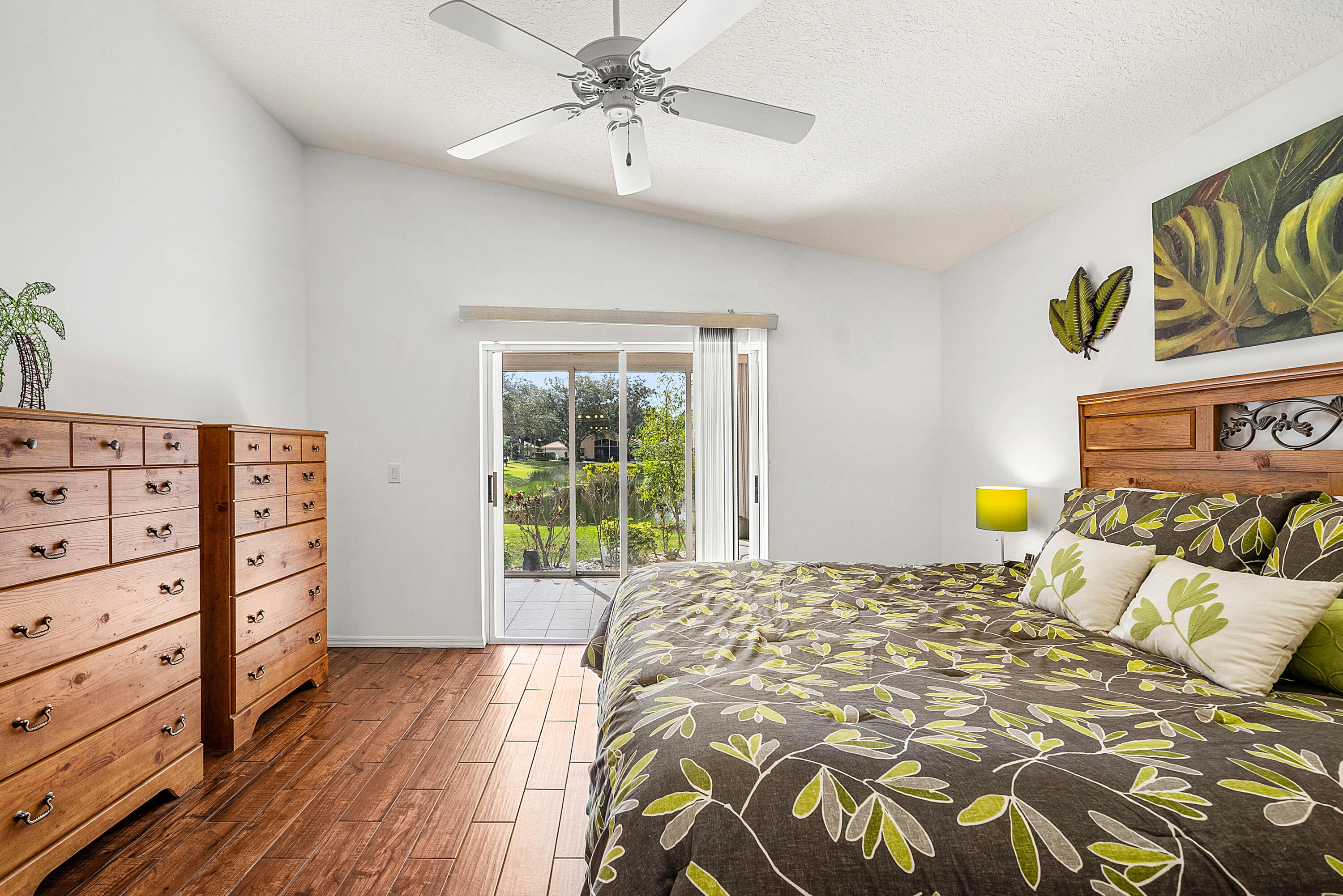 7304 Modena Drive Boynton Beach, FL 33437 - Photo 19 of 35 a bedroom with a bed and wooden floor