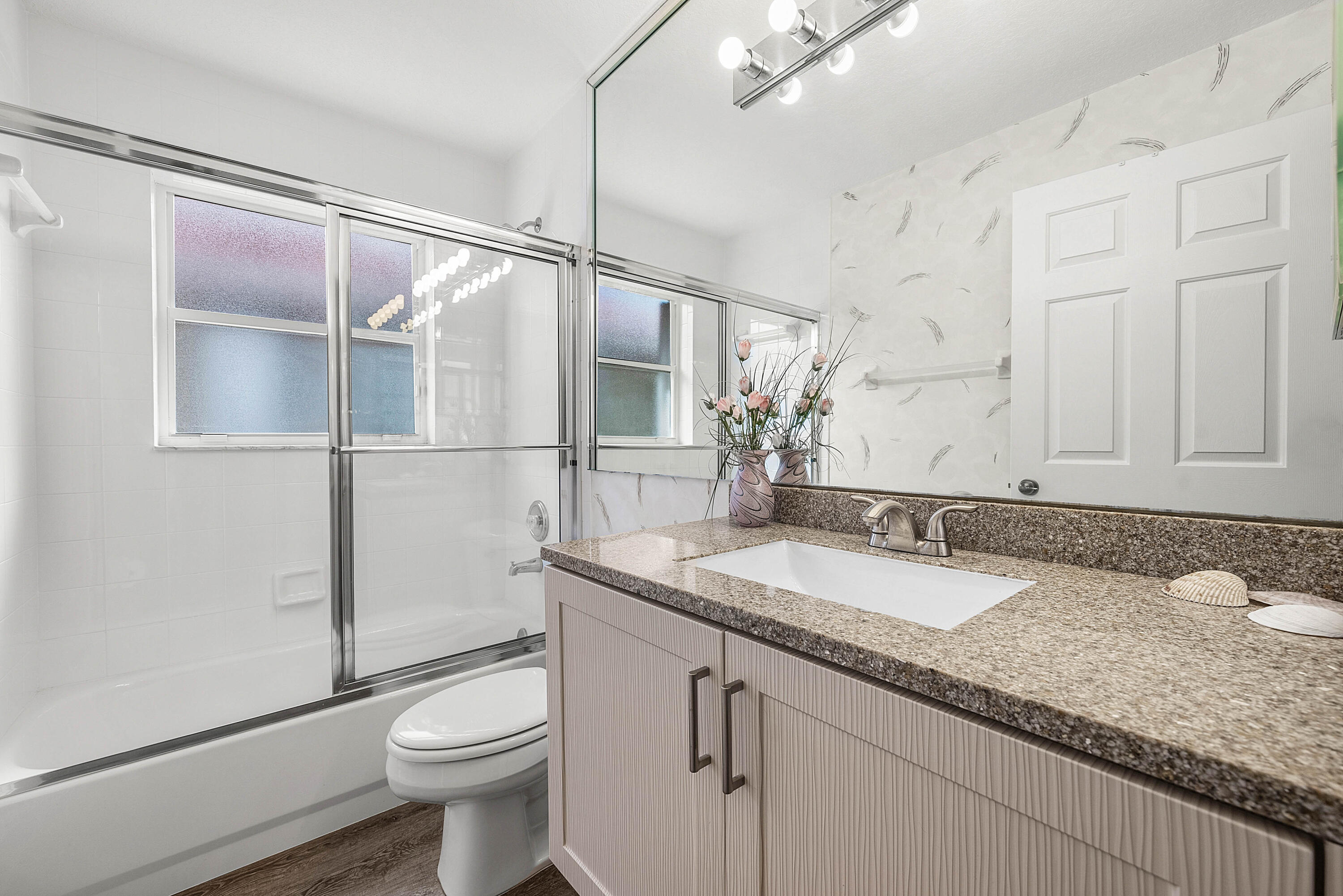 7304 Modena Drive Boynton Beach, FL 33437 - Photo 26 of 35 a bathroom with a granite countertop sink mirror vanity and toilet