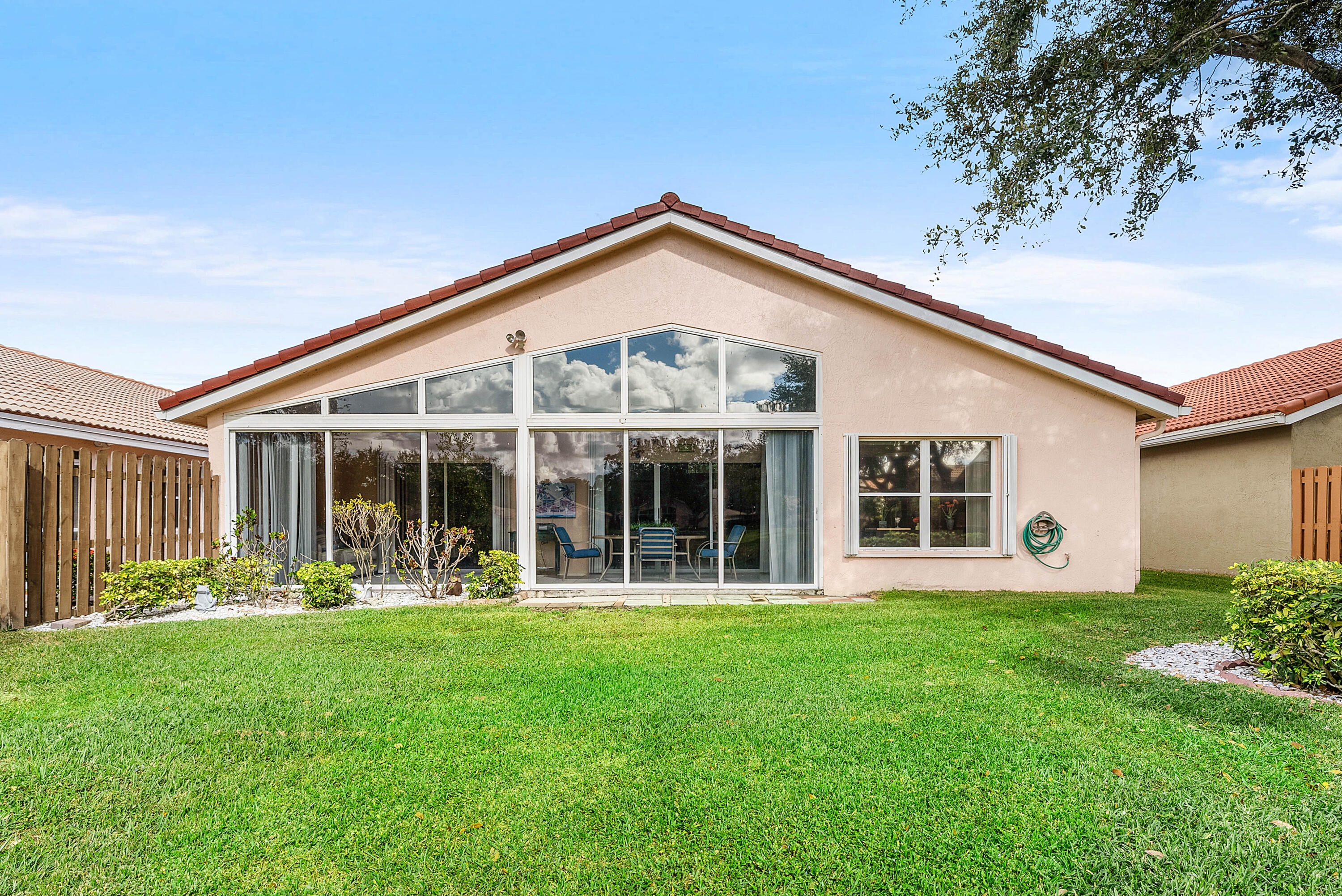 7304 Modena Drive Boynton Beach, FL 33437 - Photo 31 of 35 a front view of a house with a yard and porch
