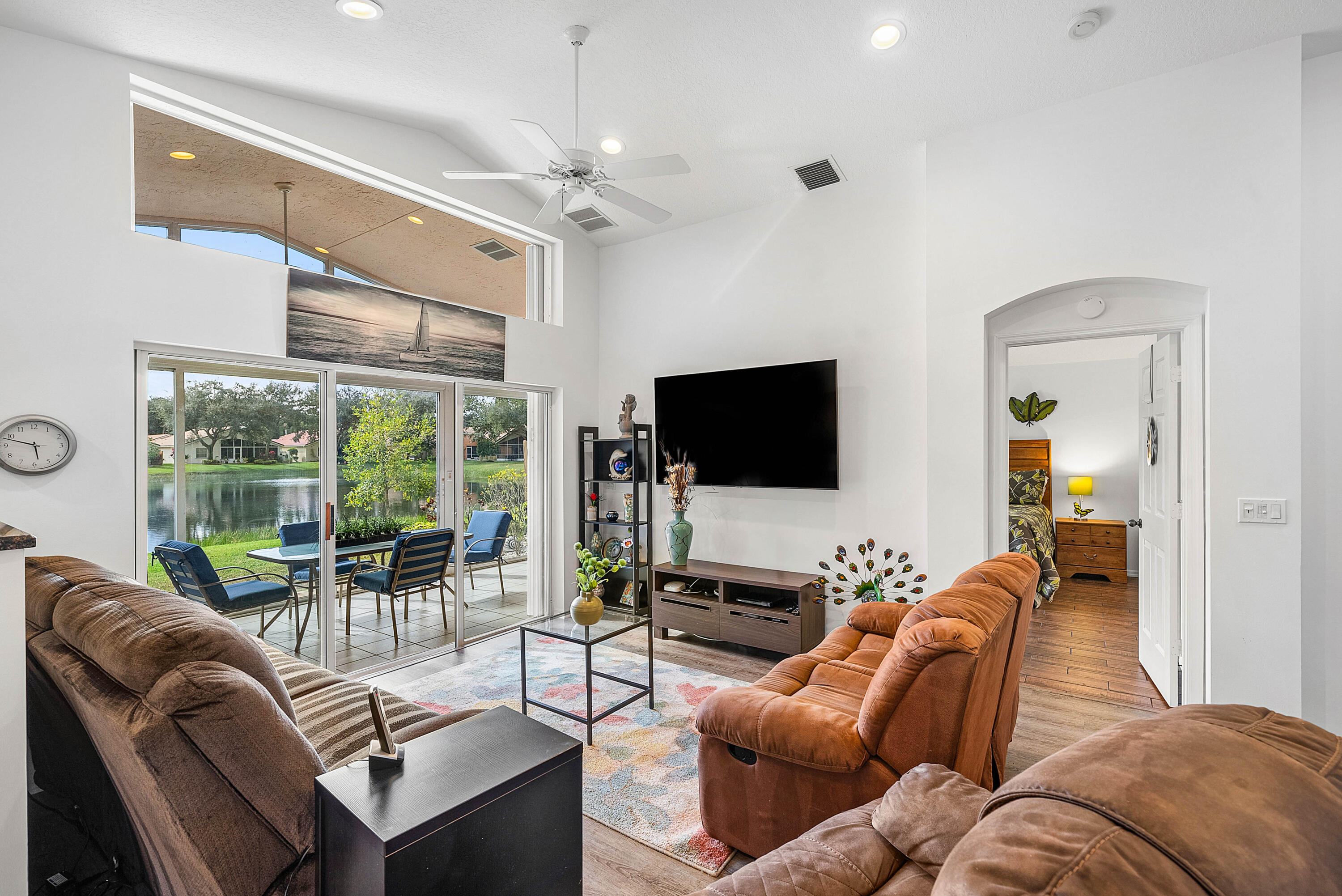 7304 Modena Drive Boynton Beach, FL 33437 - Photo 6 of 35 a living room with furniture a flat screen tv and a large window