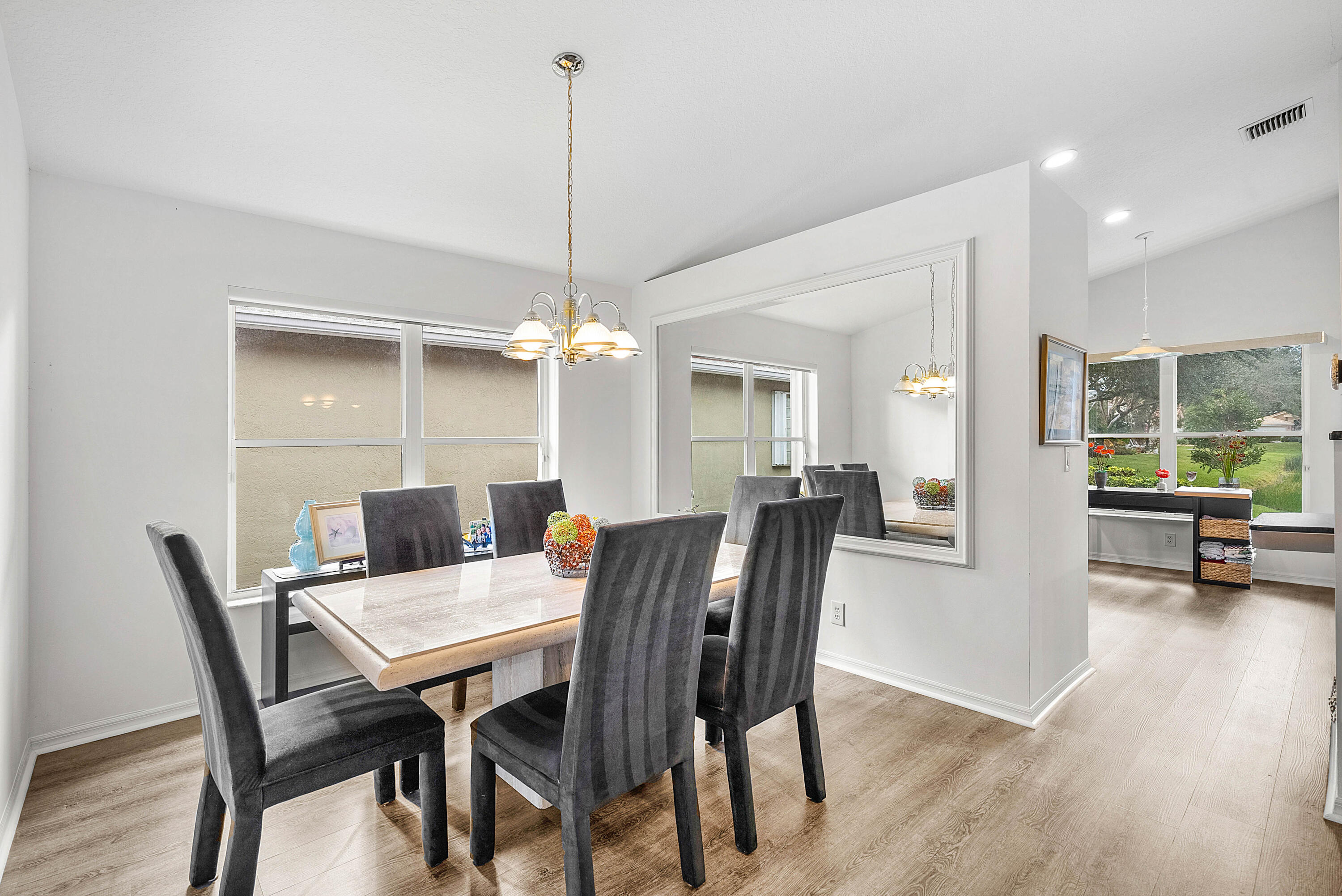 7304 Modena Drive Boynton Beach, FL 33437 - Photo 9 of 35 a view of a dining room with furniture window and wooden floor