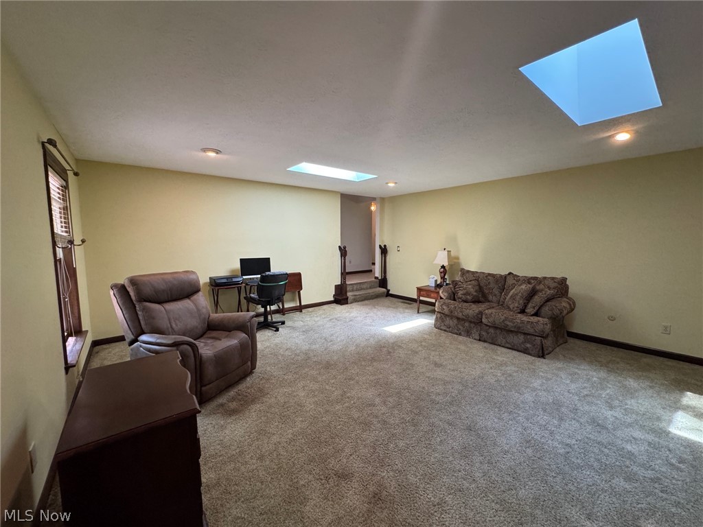 8201 Orchard Road Painesville, OH 44077 - Photo 19 of 45 Spacious room featuring two skylights, recessed lighting, wall-to-wall carpeting, and a window with horizontal blinds