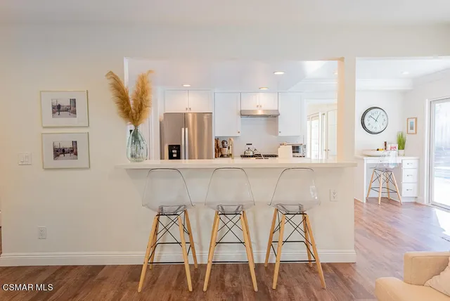 a kitchen with stainless steel appliances kitchen island a chandelier