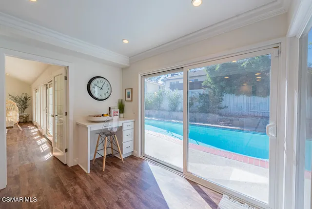 a view of a hallway view with wooden floor and workspace