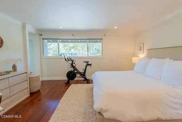 a bed room with a bed and a large window