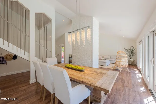 a dining room with furniture and wooden floor