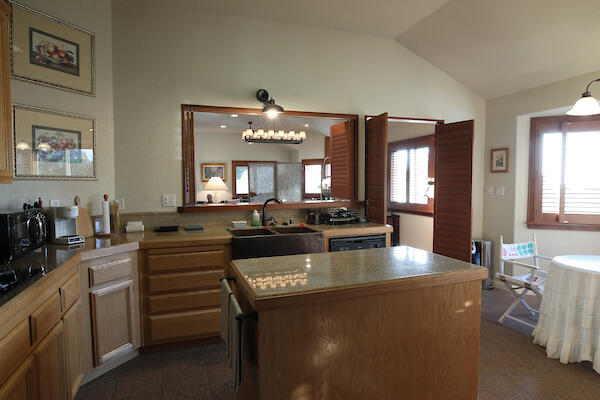 1050 Spring Road Shelter Cove, CA 95589 - Photo 35 of 42 a large kitchen with kitchen island a stove a sink a dining table and chairs