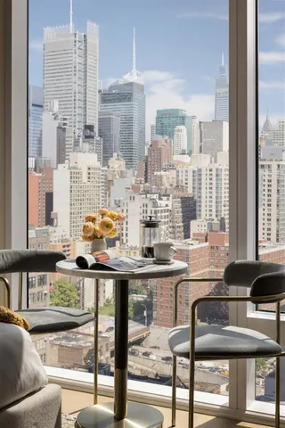 a kitchen with granite countertop a stove and white cabinets