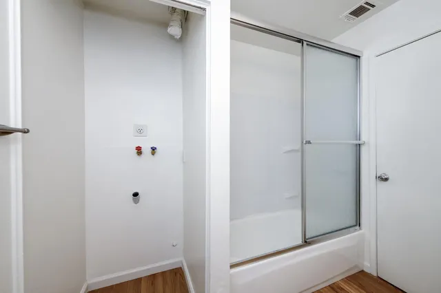 a bathroom with a glass shower door