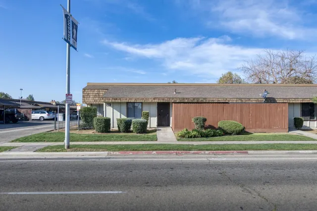 a front view of a house with a garden and plants