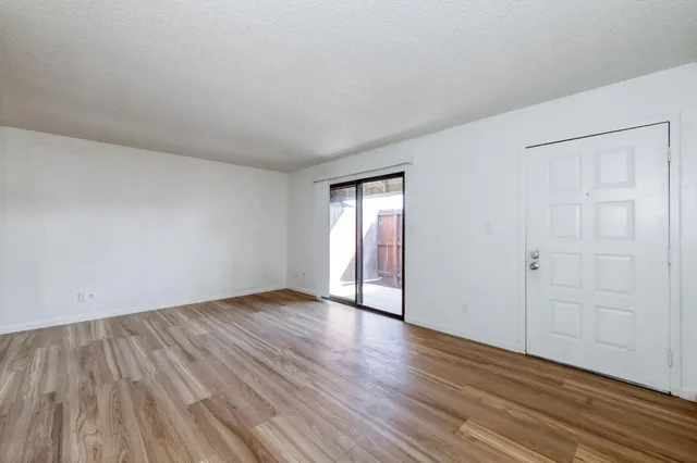 a view of an empty room and wooden floor