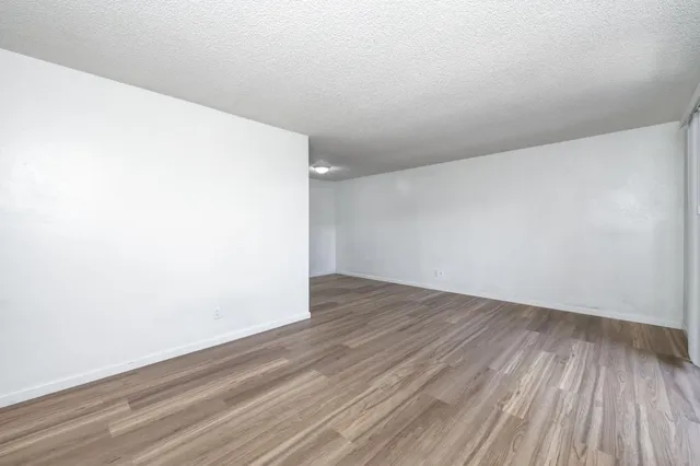 an empty room with wooden floor