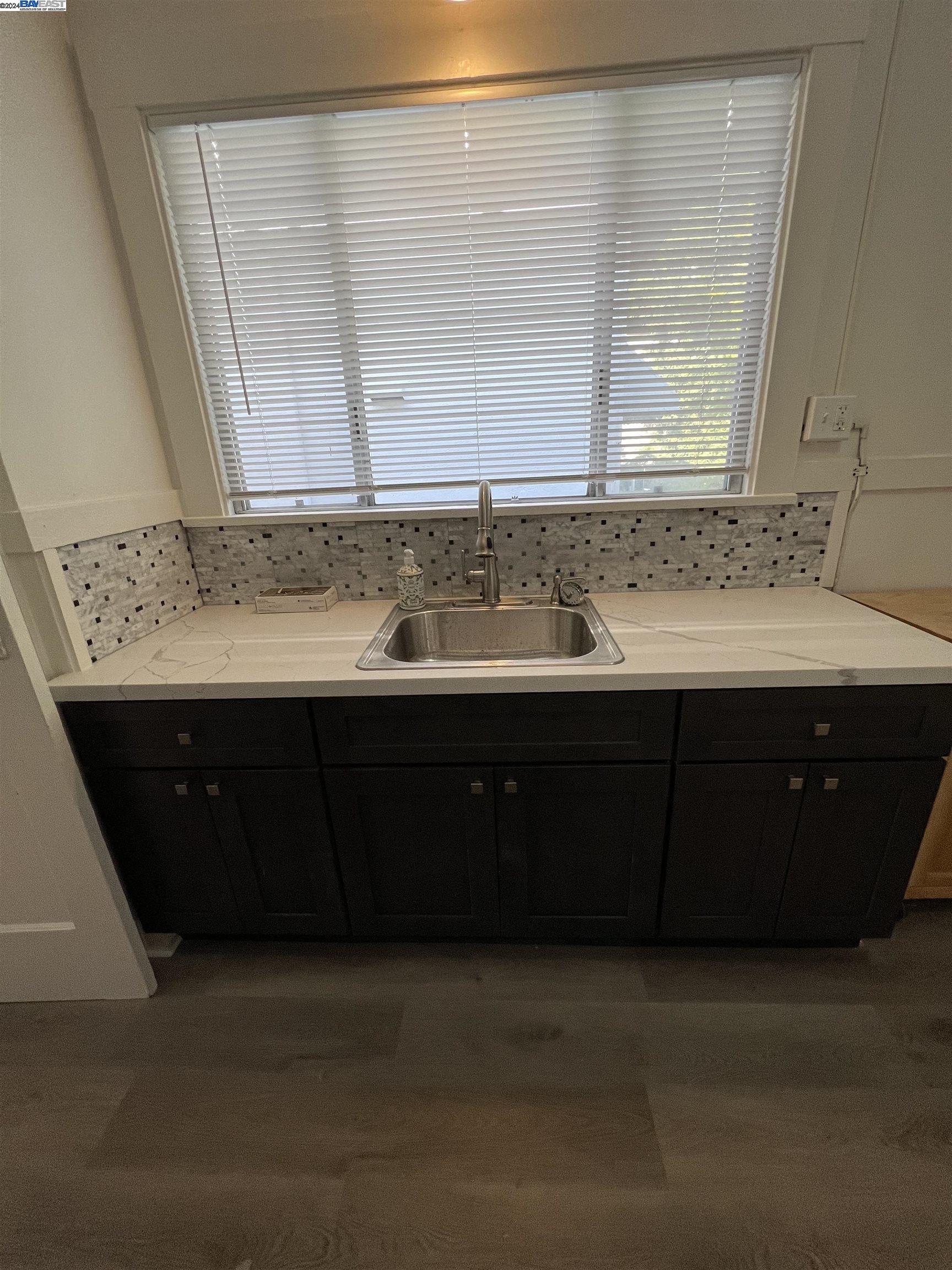 2418 Ashby Avenue, Unit # 2 Berkeley, CA 94705 - Photo 12 of 15 a bathroom with a sink and a mirror