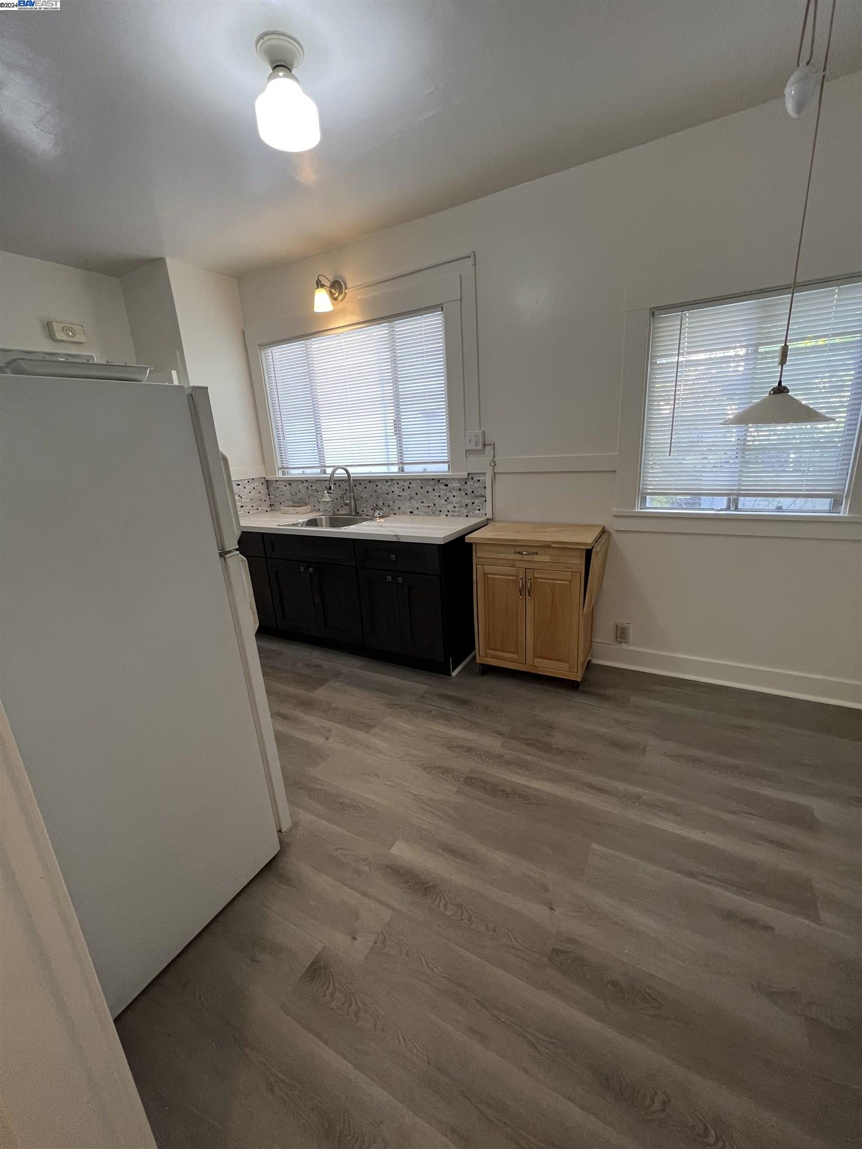 2418 Ashby Avenue, Unit # 2 Berkeley, CA 94705 - Photo 10 of 15 a living room with hard wood floors and a couch
