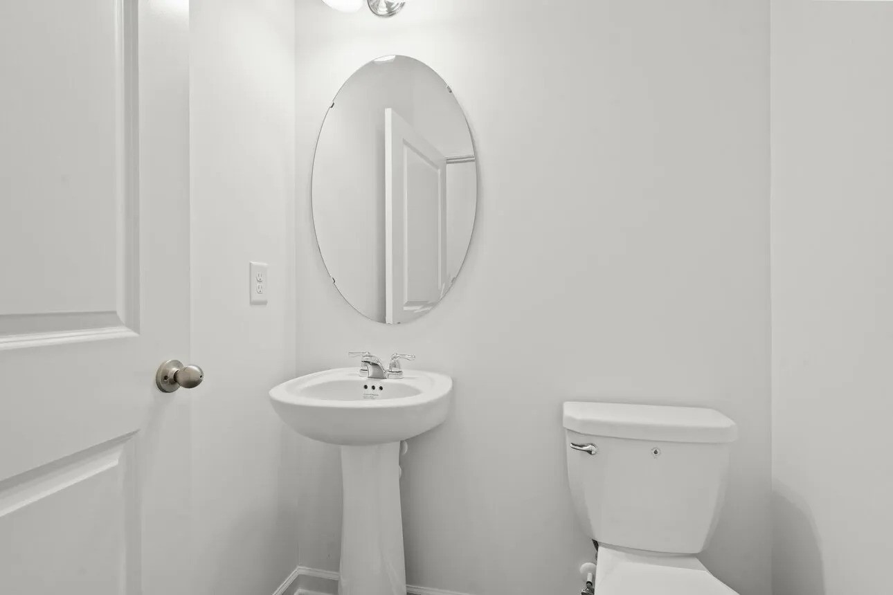 31107 Gayle Prairie Oaks Street Waller, TX 77484 - Photo 14 of 15 a bathroom with a sink a toilet and a mirror