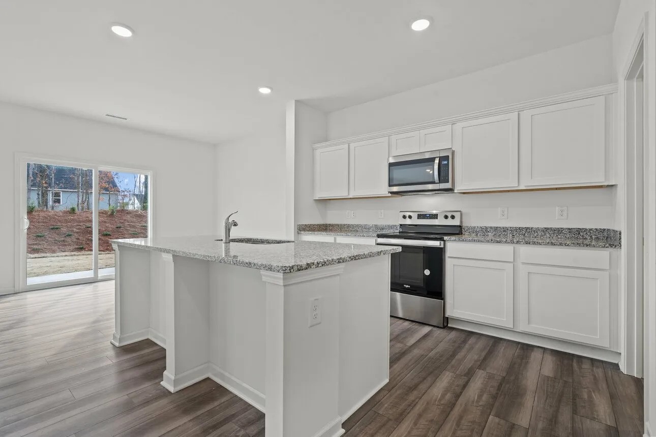 31107 Gayle Prairie Oaks Street Waller, TX 77484 - Photo 3 of 15 a kitchen with granite countertop white cabinets and white appliances