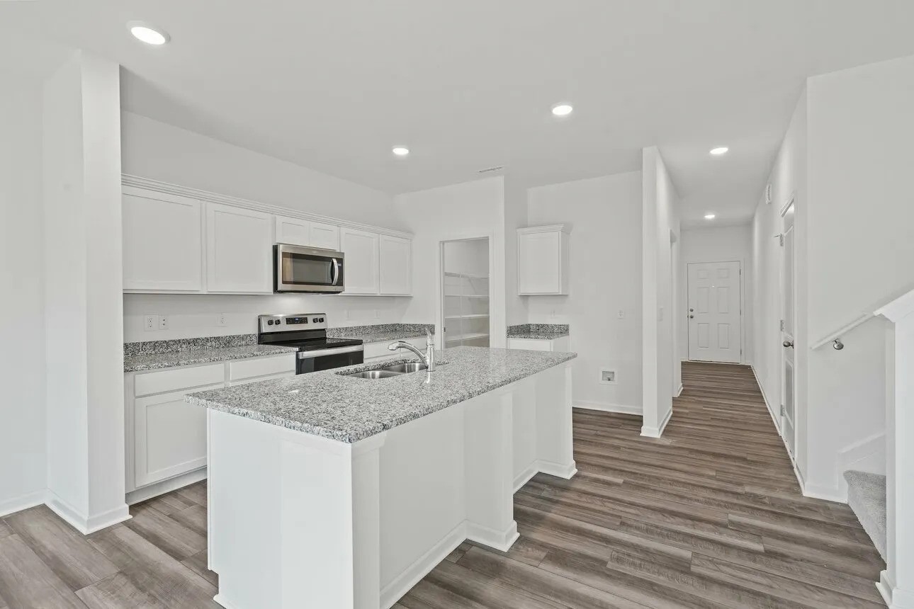 31107 Gayle Prairie Oaks Street Waller, TX 77484 - Photo 5 of 15 a view of a kitchen with granite countertop lots of counter top space and stainless steel appliances