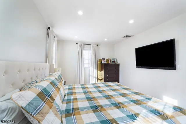 a bathroom with a tub a sink and a window