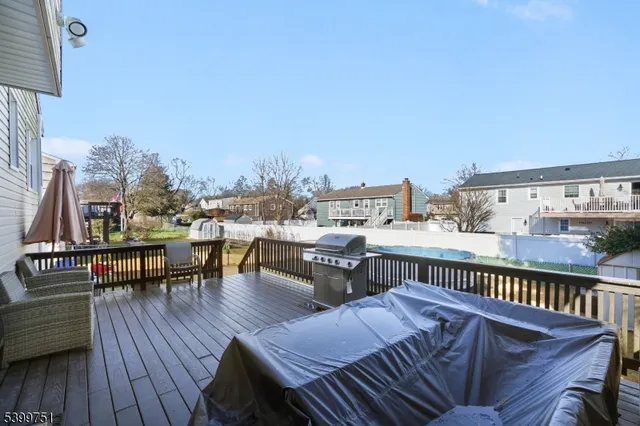 a view of a chairs and table in the backyard