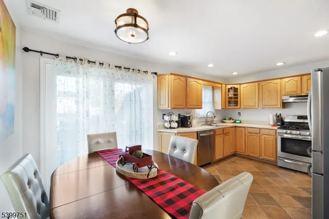 a kitchen with sink refrigerator and window