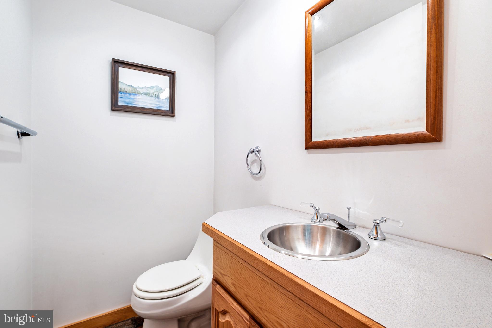 46 Grassy Lake Road Shamong, NJ 08088 - Photo 30 of 47 a bathroom with a toilet sink and mirror