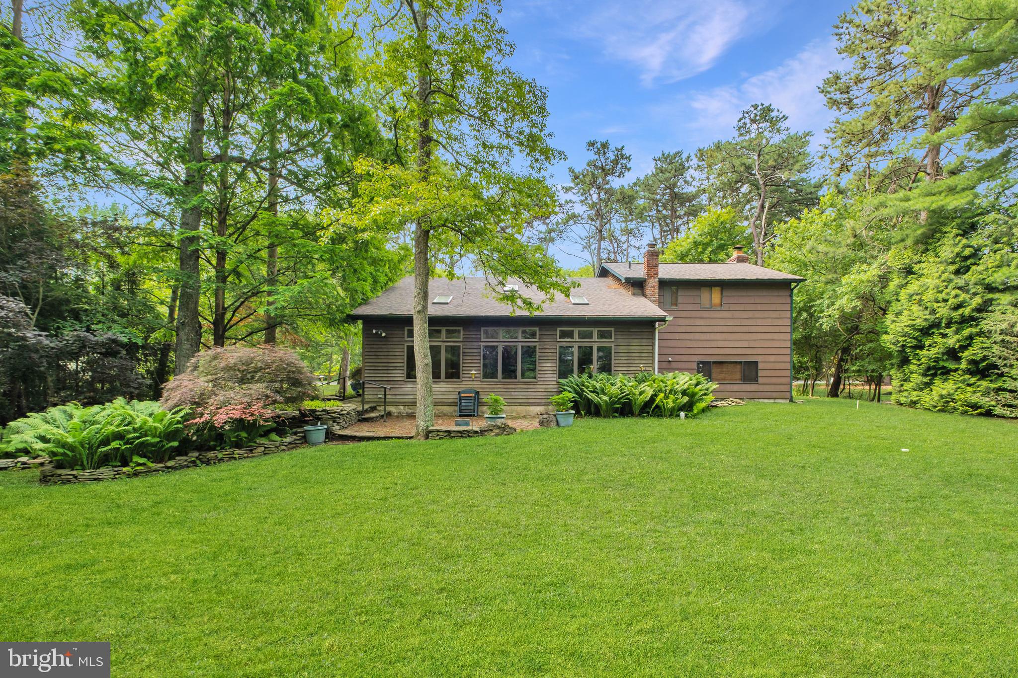 46 Grassy Lake Road Shamong, NJ 08088 - Photo 38 of 47 a front view of a house with a garden and patio