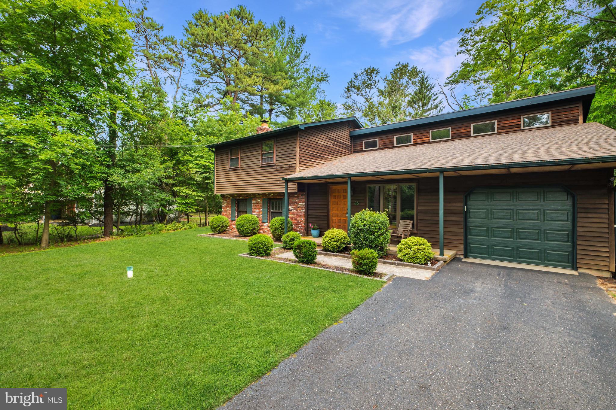 46 Grassy Lake Road Shamong, NJ 08088 - Photo 5 of 47 a front view of a house with a yard and porch