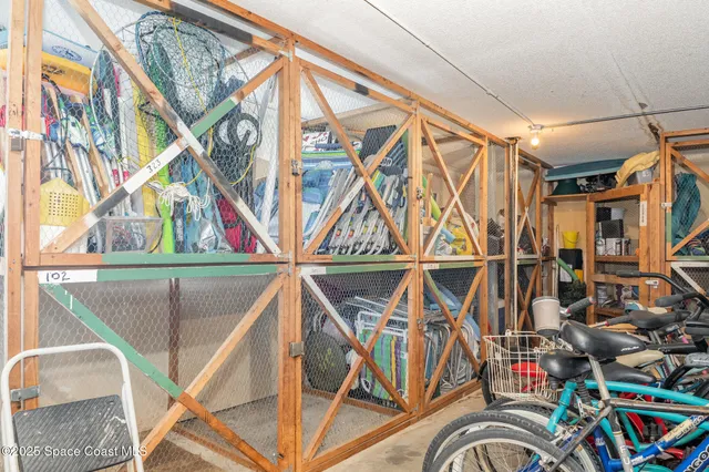 a room with lots of tables a large window and chairs