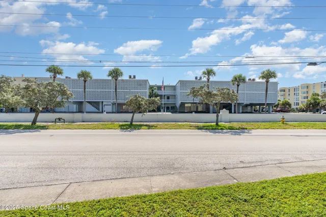 a view of open kitchen with kitchen island and stainless steel appliances