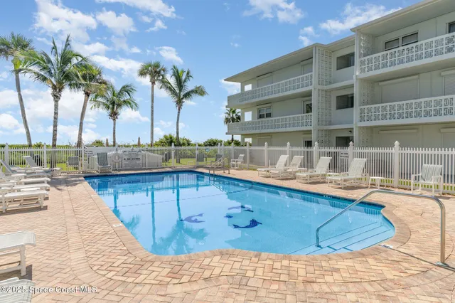 a view of a swimming pool with a lounge chairs