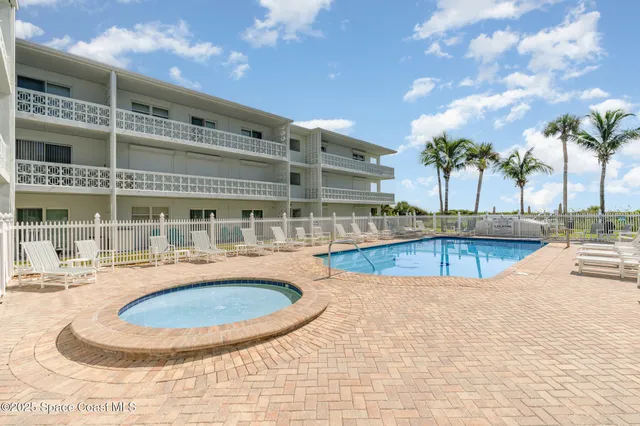 a view of a swimming pool and lounge chairs