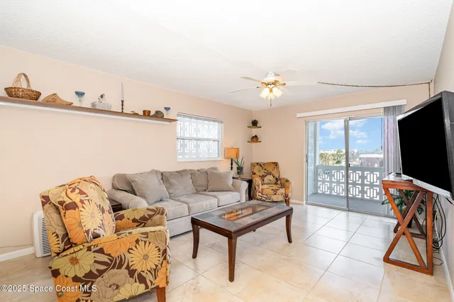 a view of a dining room with furniture and a chandelier