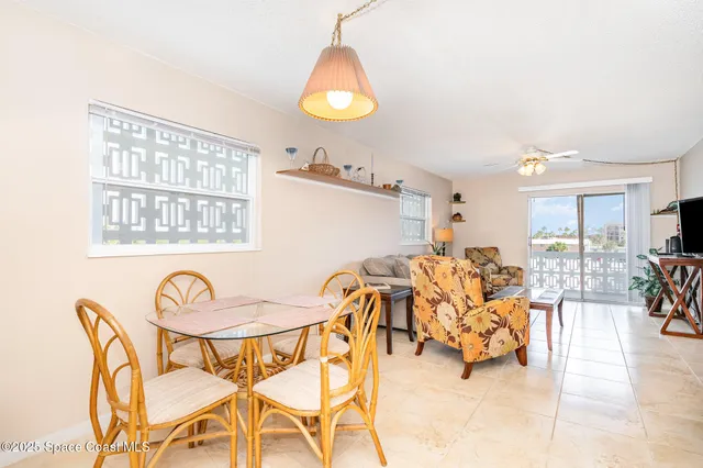 a view of a dining room with furniture and a chandelier