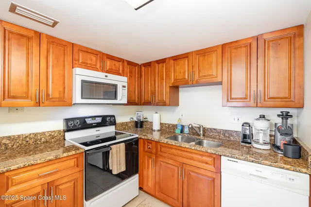 a kitchen with stainless steel appliances a refrigerator sink and cabinets