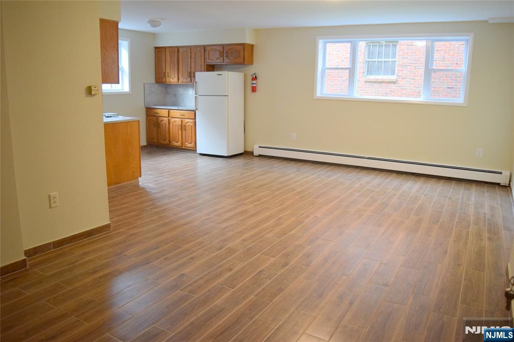533 Roff Avenue Palisades Park, NJ 07650 - Photo 12 of 16 a view of a kitchen with a fridge and wooden floor