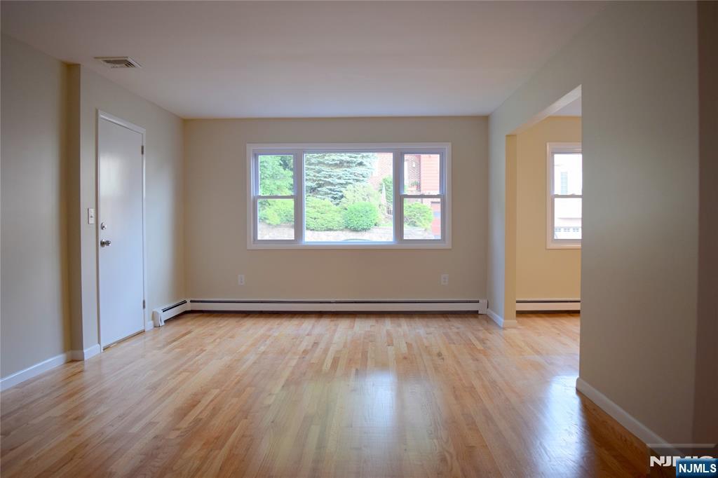 533 Roff Avenue Palisades Park, NJ 07650 - Photo 2 of 16 an empty room with wooden floor and windows