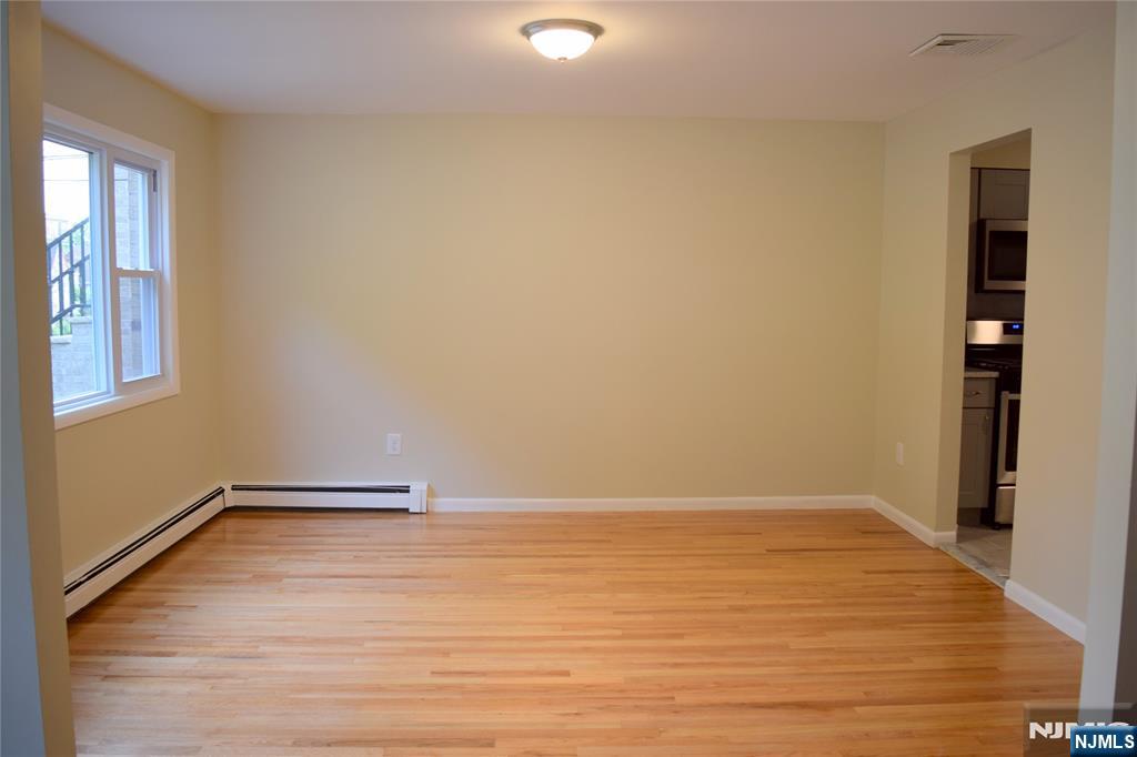 533 Roff Avenue Palisades Park, NJ 07650 - Photo 3 of 16 an empty room with wooden floor and windows