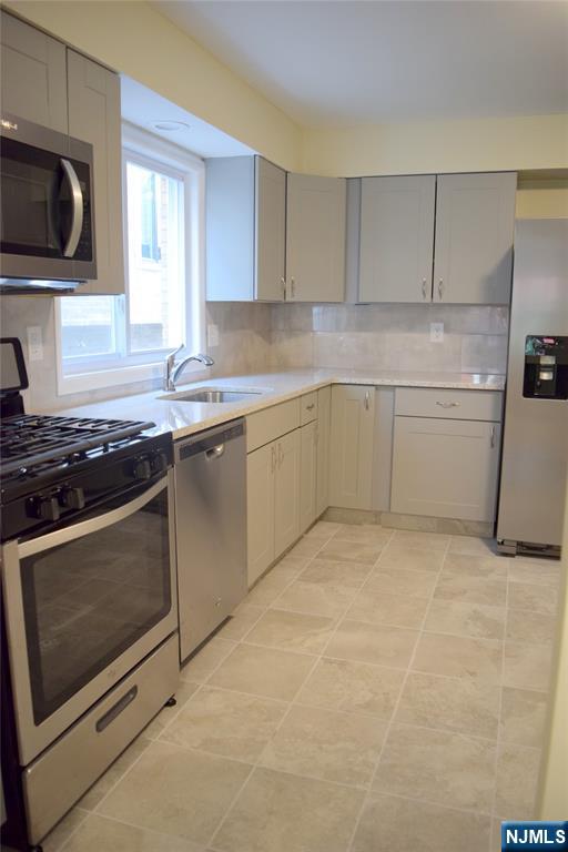 533 Roff Avenue Palisades Park, NJ 07650 - Photo 6 of 16 a kitchen with granite countertop cabinets stainless steel appliances and a sink